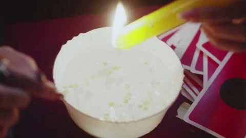 Top view of fortune teller dripping wax from the candle into the water Stock Footage 143510740