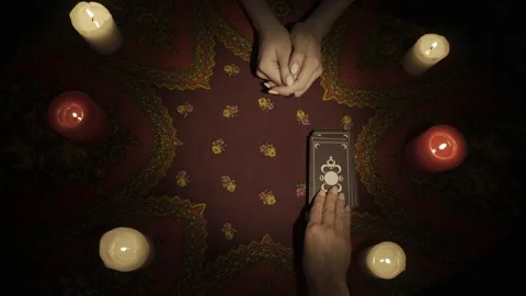 Top view, fortune teller places a deck of tarot cards on the table, female Stock Footage 248004624