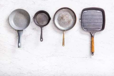 Top of view four pans on a marble table Stock Photos