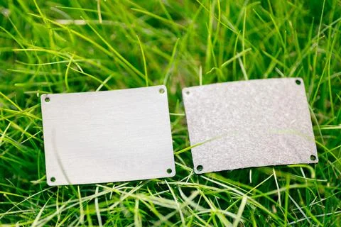 Top view of frame made of green spring grass and two gray leather patches for Stock Photos