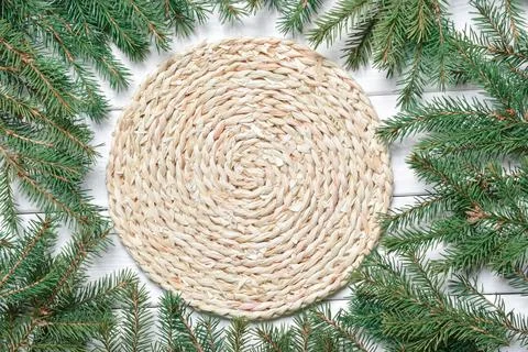 Top view of a frame made of spruce branches and a knitted natural napkin. Stock Photos