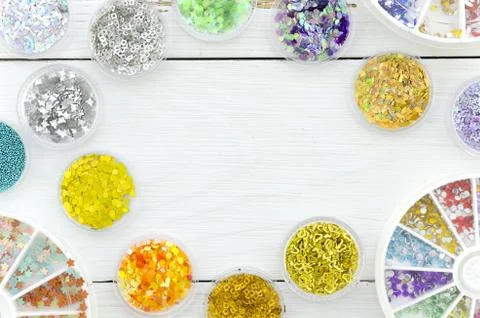 Top view frame sequins on a white workplace with copy space in the middle Stock Photos
