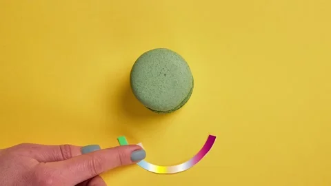 Top view of french macaroons changing color on yellow background. Stock Footage 146510899