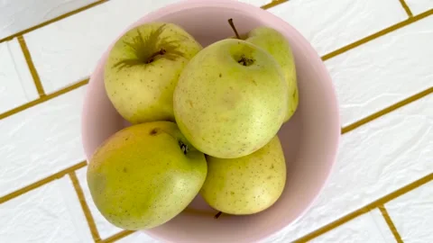 Top View Fresh Apples in Pink Bowl on Kitchen Counter Healthy Organic Fruit F Stock Footage 333683128