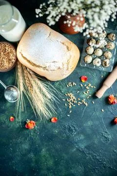 Top view fresh bread with milk and eggs on dark-blue background bake cake b.. Stock Photos
