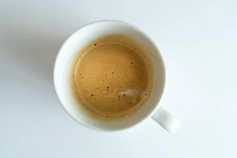 Top view of fresh espresso cup with thick golden crema isolated on white. Min Stock Photos