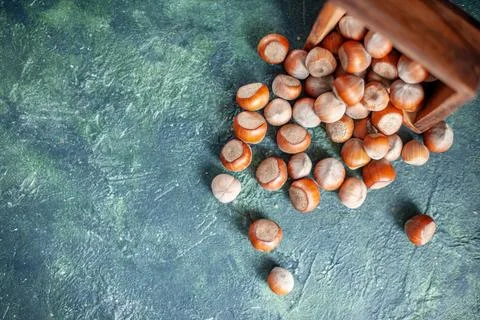 Top view fresh hazelnuts on dark-blue background shell nut photo walnut pea.. Stock Photos