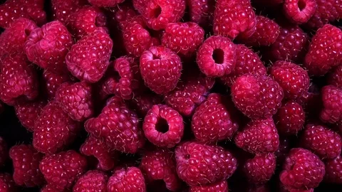 Top view of fresh juicy raspberries rotating in 4K Stock Footage 78371353