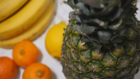 Top View Of Fresh Natural Pineapple Rotating On A Fruit Background On The Right  스톡 동영상 128588066