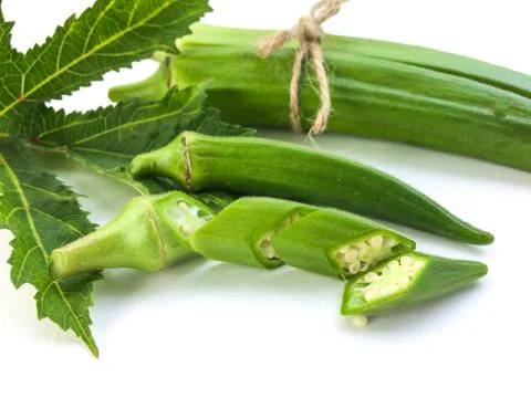Top view fresh okra slice and leaf white background. Foto stock