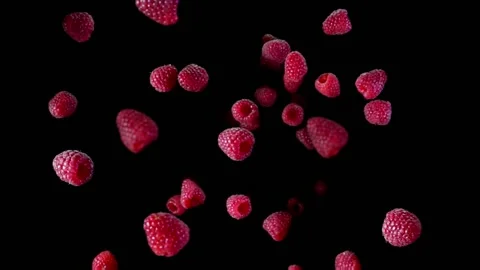 Top view of the fresh raspberries bouncing and rotating on the black background Stock Footage 203043244