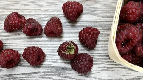 Top View Fresh Raspberry Berries And A White Birch Bark Box On A Wooden Table Pa Stock Footage 116655524