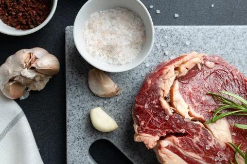 Top view of Fresh Raw Beef Steak With Salt on Cutting Board Stock Photos