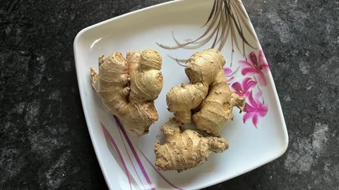 Top view of fresh raw ginger roots on a white decorative plate 動画素材 328441270