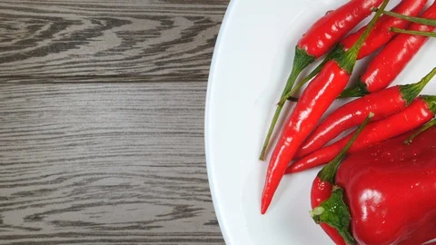 Top View Of Fresh Raw Red Chili Peppers And Ramiro Pepper With Water Drops Rotat Vídeo Stock 128597740