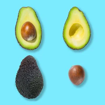 Top view of fresh ripe whole avocado fruit isolated on blue background Stock Photos