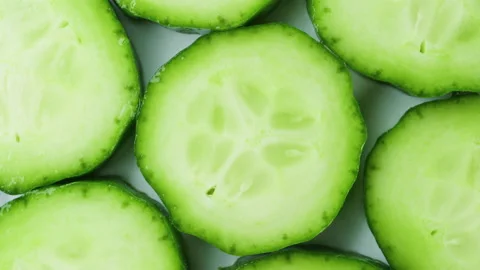 Top view of fresh sliced cucumber rotation. 4K Macro Stock Footage 154738816