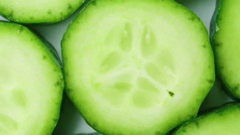 Top view of fresh sliced cucumber rotation. 4K Macro Stock Footage 154739129