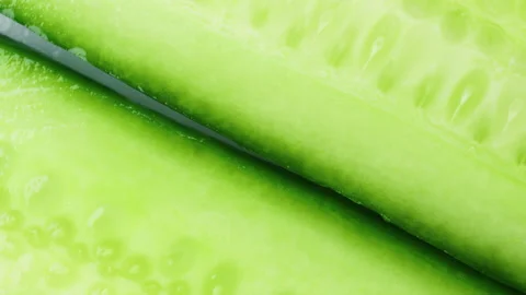 Top view of fresh sliced cucumber rotation. 4K Macro Stock Footage 154739220