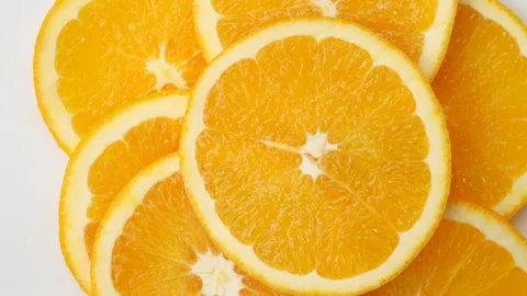 Top view of fresh sliced orange fruit rotation. Stock Footage 135589186