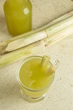 Top view of fresh sugar cane and sugar cane juice on marble Stock Photos