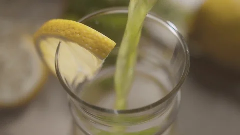 Top view of fresh summer refreshing drink being poured into glass cup Stock Footage 114808173