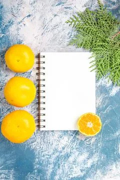 Top view fresh tangerines with notepad on light-blue background fruit citru.. Fotos Stock