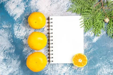 Top view fresh tangerines with notepad on a light-blue background fruit cit.. Fotos Stock