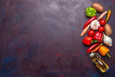 Top view fresh vegetables with olive oil on dark background meal food veget.. Stock Photos
