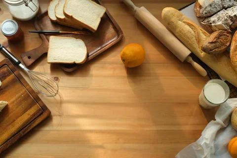 Top view of freshly baked bread  and kitchen utensils on wooden table with .. Stock Photos