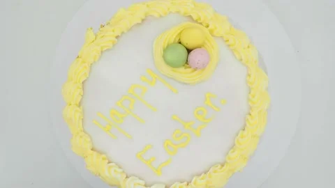 Top View Of A Freshly Baked Easter Cake Rotating On A White Background Stock Footage 151628258