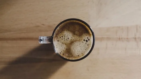 A top view of a freshly brewed coffee, very creamy. The image moves verticall Stock Footage 92102053