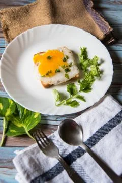 Top view of fried eggs with bacon and bread in a white plate Stock Photos