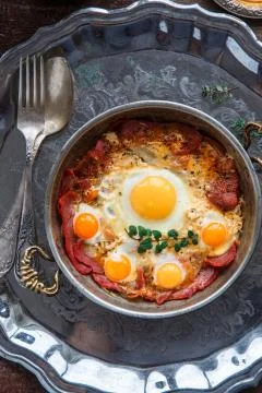 Top view of fried eggs with cured meat, turkish breakfast pastirmali yumurta Stock Photos