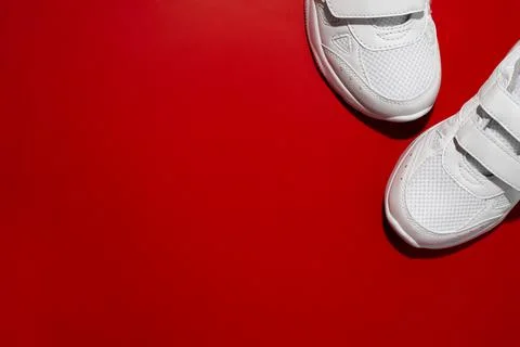 Top view the front of two white sports sneakers in the corner with copy space Stock Photos