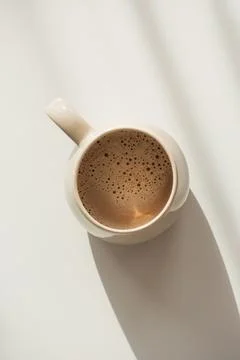 Top View on Frothy Coffee in Ceramic Mug. Cozy Morning Flatlay Stock Photos