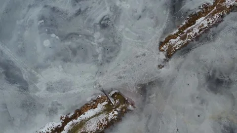 Top view to frozen lake pattern with two parts of peninsula Stock-Footage 237688735