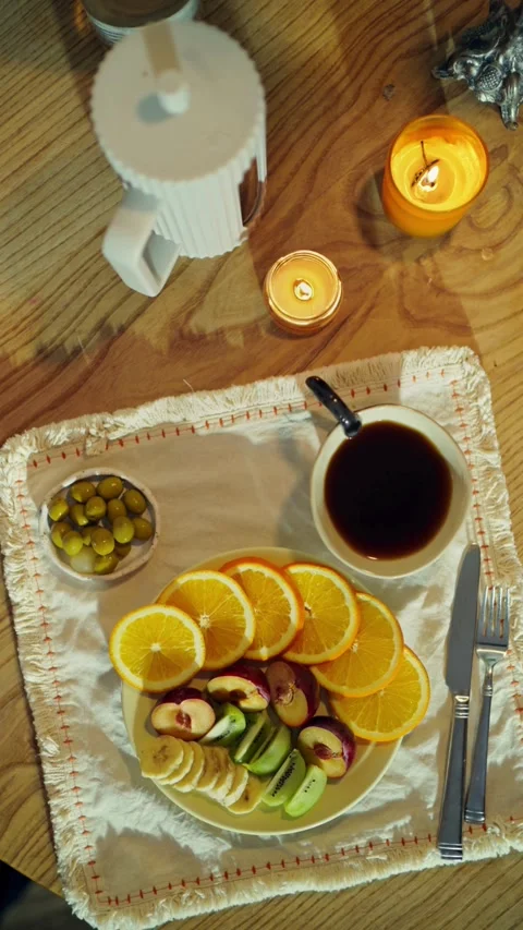 Top view of fruit plate coffee and candles breakfast 動画素材 331774498
