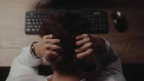 Top view of frustrated tired young businessman feeling despair and stress at Stock Footage 342930111