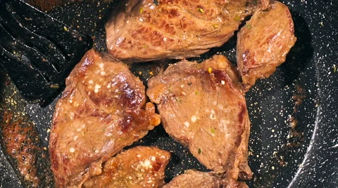 Top view of frying beef steak in a frying pan. Meat preparation Stock Footage 66448565