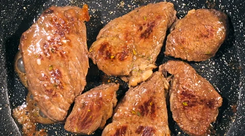Top view of frying beef steak in a frying pan. Meat preparation Stock Footage 66448616