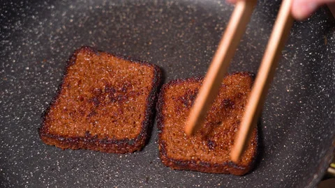 Top view of frying bread toasts in the pan Stock Footage 249392608