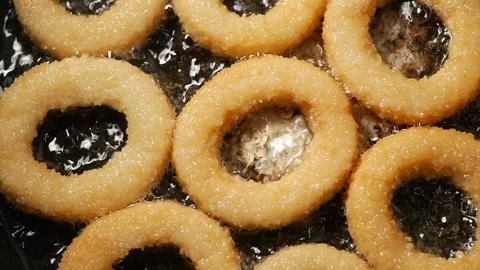 Top view of frying onion ring on a cooking pan Stockbeeldmateriaal 333442265