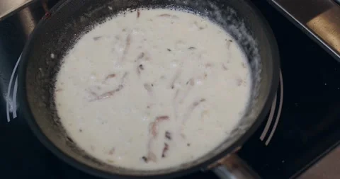 Top view of frying pan with pasta in cream sauce Stock Footage 221634580