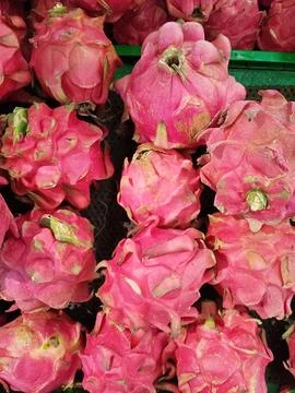 Top view full frame pattern of fresh red pitaya dragon fruits at market displ Stock Photos