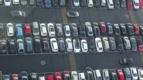 Top View of a Full Parking Lot With Passing Cars Stock Footage 260335291