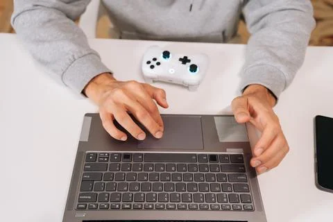 Top view of gamer hands navigating laptop touchpad, using contemporary gaming Stock-Fotos