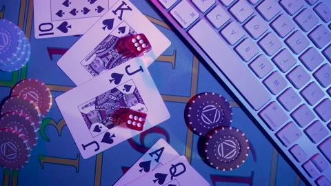Top view of gaming table with computer keyboard, cards, dice and casino chips Stock Footage 187507404