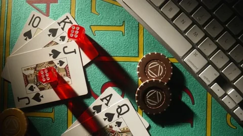 Top view of gaming table with computer keyboard, cards, dice and casino chips Stock Footage 187507737