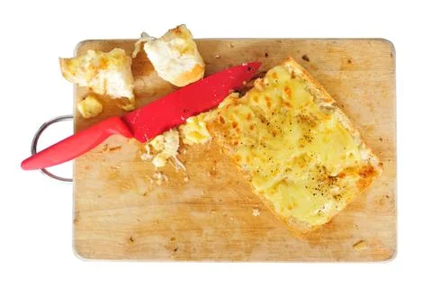 Top view garlic bread with red knife on the chopping block isolated Stock Photos
